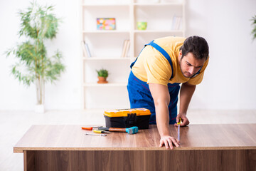 Young male carpenter working indoors