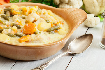 Vegetable soup with ingredients carrot, cauliflower, potato and