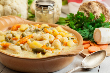 Vegetable soup with ingredients carrot, cauliflower, potato and parsley