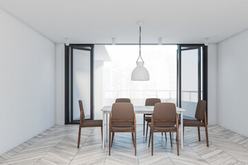 White dining room with brown chairs and balcony