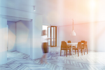Woman walking in white dining room