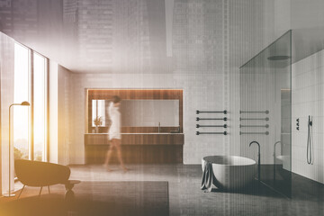 Woman walking in luxury bathroom with shower