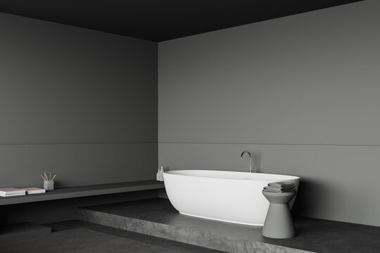 Grey bathroom corner with tub and shelf