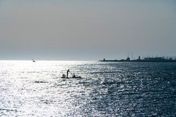 Fototapeta premium man in a boat backlight with reflections on the mediterranean sea