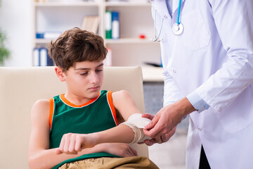 Sick boy visiting young male doctor pediatrician