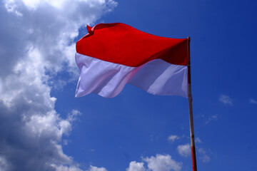 Indonesia Flag Fluttered in the Blue Sky. Indonesian Independence Day.