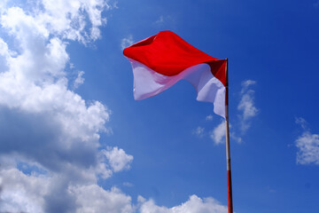 Indonesia Flag Fluttered in the Blue Sky. Indonesian Independence Day.