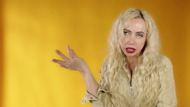 What's wrong. The embarrassed and intense woman shrugged, spread her arms. Shocked bewildered woman blonde colleague shrugging shoulders complete disbelief asks a question doubts puzzled situation