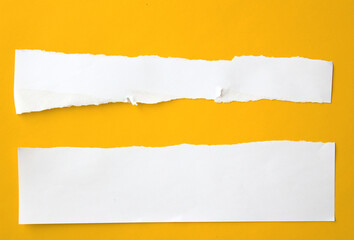 Ripped paper on yellow background.