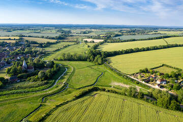 Beautiful drone landscape image over lush green Summer English countryside during late afternoon light