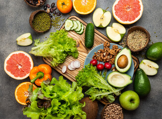 Obraz na płótnie Canvas Healthy vegan diet food concept vegetables greens nuts. Top view.