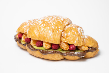 close up photo of a croissant with stuffing on a white background