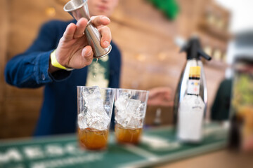bartender makes an alcoholic cocktail
