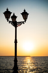 Obraz premium beautiful photo of a lantern at sunset on the sea