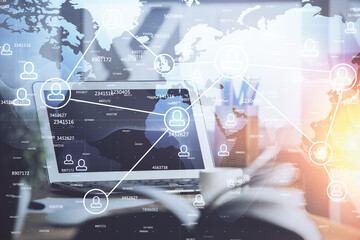 Computer on desktop with social network hologram. Double exposure. Concept of international people connections.