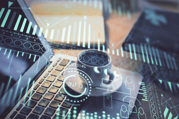 Computer on desktop in office with technology theme hologram. Double exposure. Tech concept.