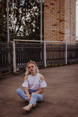 Fototapeta na wymiar young woman sitting on a bridge