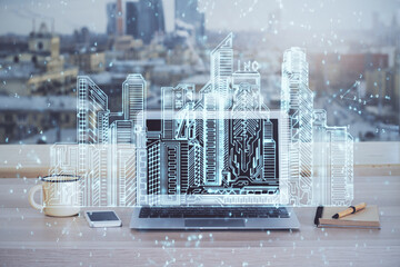 Desktop computer background in office and big town buildings hologram drawing. Double exposure. Smart city concept.