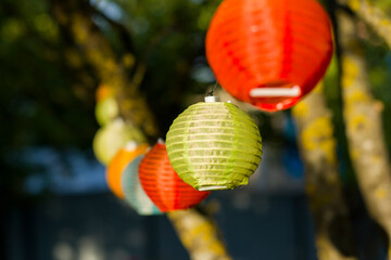 Lantern in the yard on the tree bokeh background, night and warm light, hanging lanterns.