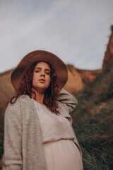 young pregnant woman with basket in the desert