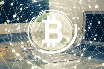 Multi exposure of blockchain theme hologram and table with computer background. Concept of bitcoin crypto currency.