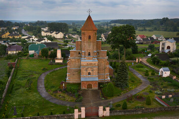 A unique defensive temple in a small Belarusian village on a summer evening. The architectural...