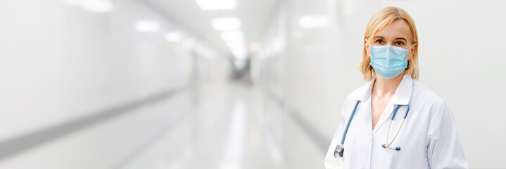 Doctor wear face mask in hospital protect from coronavirus disease or COVID-19. Medical staff are...