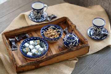 Wooden handmade trays with sweets and nuts on ceramic plates. Say no to plastic. Eco concept