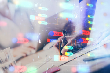 Naklejka premium Double exposure of woman's writing hand on background with data technology hud. Big data concept.