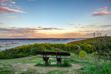 beautiful landscape overlooking the river. bench in the foreground