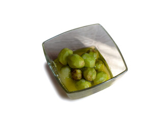 Cleaned Greek nuts with sugar for jam in a glass container. European jam with nuts, a iodine source for health