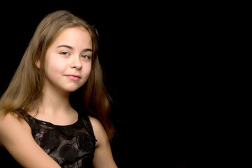 Naklejka premium Close-up.Portrait of a cute little girl on a black background.