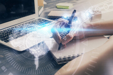 Multi exposure of writing hand on background with brain hologram. Concept of learning.