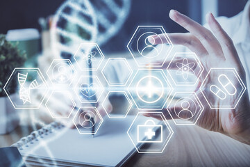 DNA theme hologram over woman's hands writing background. Concept of education. Double exposure