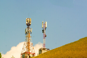 two Mobile phone tower amid blue sky, communication