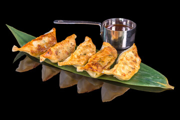 Delicious gyoza, steamed dough on Chinese recipe with reflection, isolated on black background