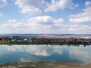 Fototapeta na wymiar Scenic view of Sava river and settlements around Slavonski Brod during sunny day with fluffy clouds.