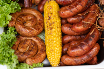 delicious grilled sausages with salad and vegetables