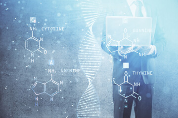 DNA hologram with businessman working on computer on background. Concept of bioengineering. Double...