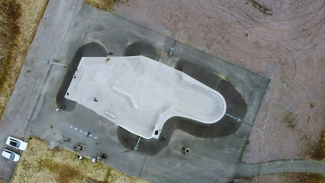 Top View Of A Skatepark In Kållered, Mölndal, Sweden With Few People And A Skater - aerial drone
