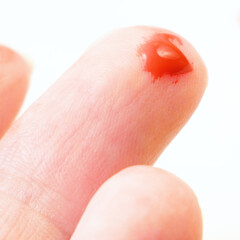 hand with red blood drop  on white background, medical test concept