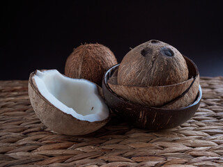 Authentic buddha bowl from coconut shells with mature coconuts on the table, closeup. Eco friendly...
