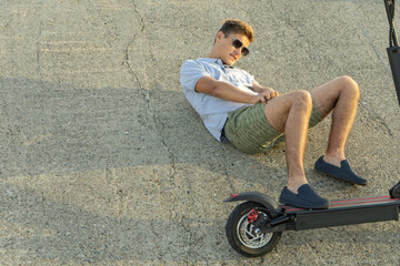 Young boy accident with an electric scooter on street © Aleksandr