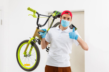 Man wearing a face mask with bike. Coronavirus pandemic protection.