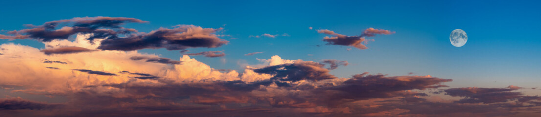 Blue sky background panorama with orange clouds and moon