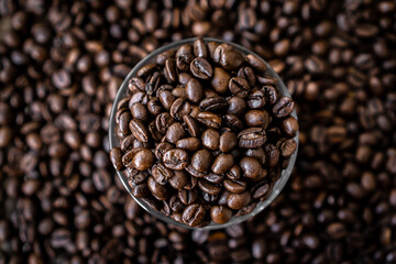 coffee beans in glass and background. Top view