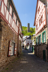Narrow paved road in Monreal with Löwenburg in the background