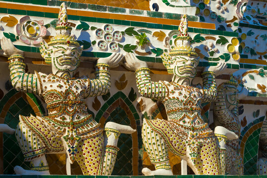Sculptures of Rakshasa demons supporting the main prang of the Temple of the Morning Dawn (Wat Arun). Bangkok, Thailand