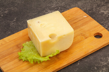 Emmental cheese over wooden board