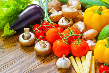 Assortment of fresh vegetables. Carrot garlic kohlrabi onion celery cucumber parsnip and radish on table.